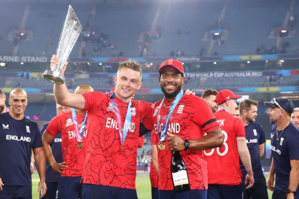 MELBOURNE, AUSTRALIA - NOVEMBER 13:  Sam Curran and Chris Jordan of England pose with the trophy as they celebrate victory in the ICC Men's T20 World Cup Final match between Pakistan and England at the Melbourne Cricket Ground on November 13, 2022 in Melbourne, Australia. (Photo by Mark Kolbe/Getty Images)