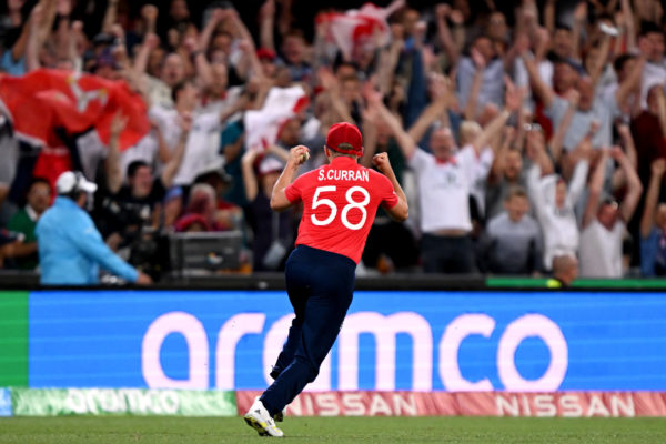 BRISBANE, AUSTRALIA - NOVEMBER 01: Sam Curran of England celebrates towards the English fans after taking the catch to dismiss James Neesham of New Zealand during the ICC Men's T20 World Cup match between England and New Zealand at The Gabba on November 01, 2022 in Brisbane, Australia. (Photo by Bradley Kanaris/Getty Images)