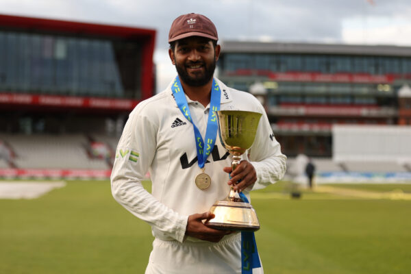 Lancashire v Surrey - LV= Insurance County Championship MANCHESTER, ENGLAND - SEPTEMBER 28: Ryan Patel of Surrey with the LV= Insurance County Championship Division One Trophy after the match between Lancashire and Surrey at Emirates Old Trafford on September 28, 2022 in Manchester, England. (Photo by Nathan Stirk/Getty Images for Surrey CCC)