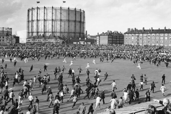 Players from the England cricket team run to the safety of the pavilion as crowds of spectators invade the pitch after the West Indies cricket team won the Fifth Test on 26th August 1963 at the Kennington Oval cricket ground in London, England. West Indies won the match by 8 wickets and won the series against England by three matches to one, with one game drawn. (Photo by Central Press/Hulton Archive/Getty Images)
